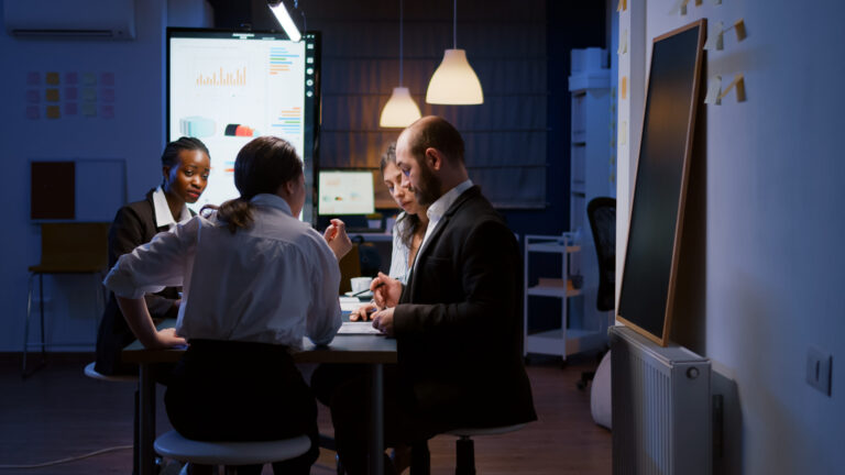 Selective focus of diverse multi-ethnic businesspeople overworking late at night